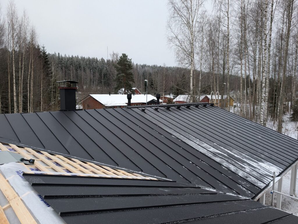 Katon myrskyvaurio, jossa irronnut kattopelti vaatii ammattilaisen suojausta